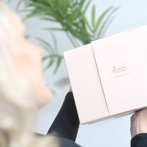 model showing a gift box which can be purchased with the poncho