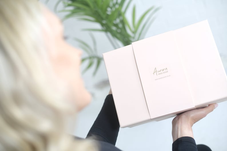 model showing a gift box which can be purchased with the poncho