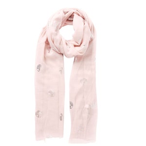 a light pink lightweight scarf around the neck, the scarf has an all over silver foil tree of life pattern, the trees are encased in a circle.