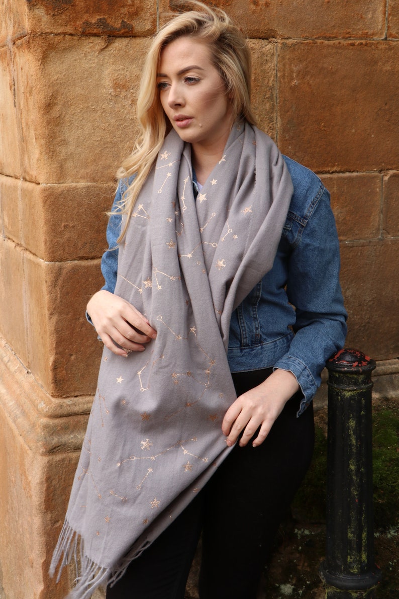 model wearing a warm winter scarf with a constellation and star print