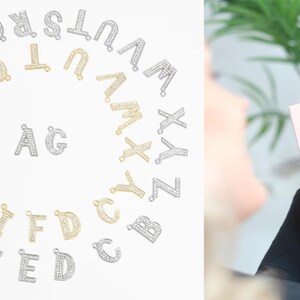 May include: A set of silver and gold letter charms with rhinestones. The letters are arranged in a circle on a white background. The letters are A, B, C, D, E, F, G, H, I, J, K, L, M, N, O, P, Q, R, S, T, U, V, W, X, Y, and Z.