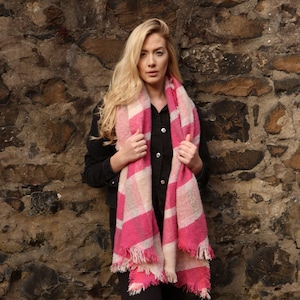 model wearing an oversized fuchsia pink winter scarf