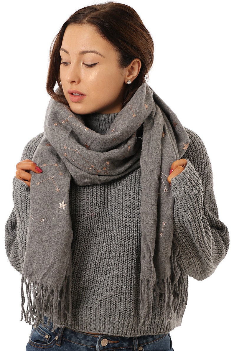 model wearing a warm winter constellation scarf in grey and gold foil