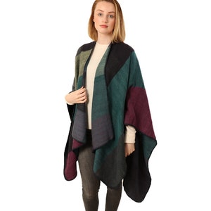 model wearing the poncho cape over a sweater