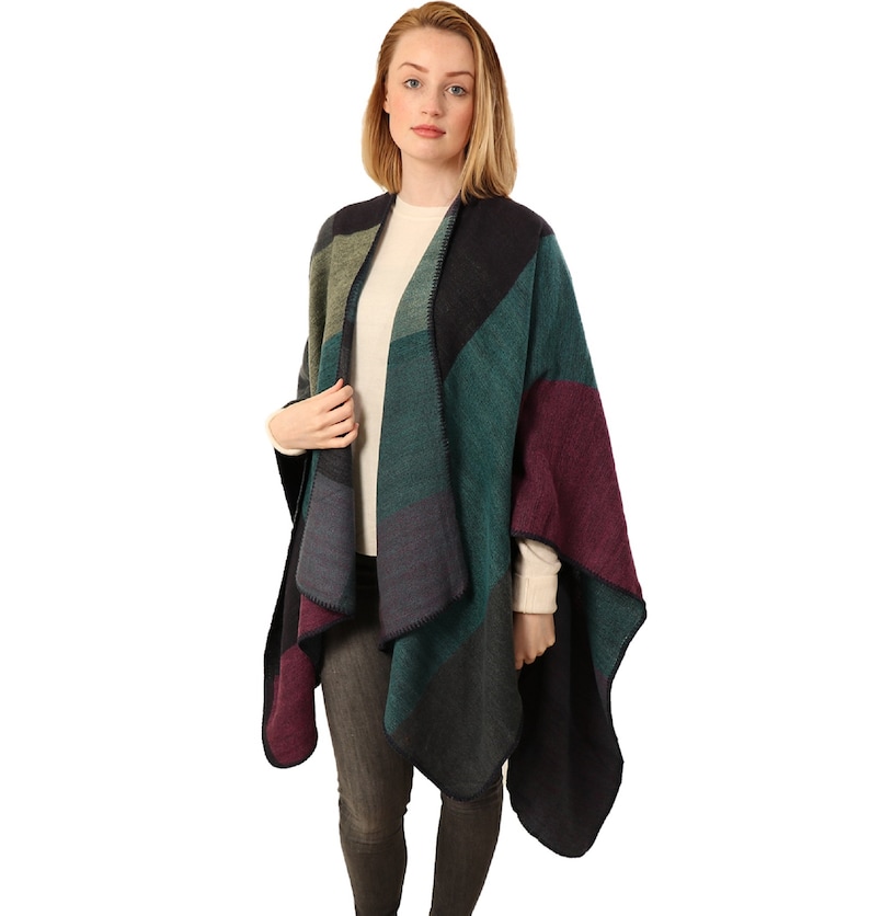 model wearing the poncho cape over a sweater
