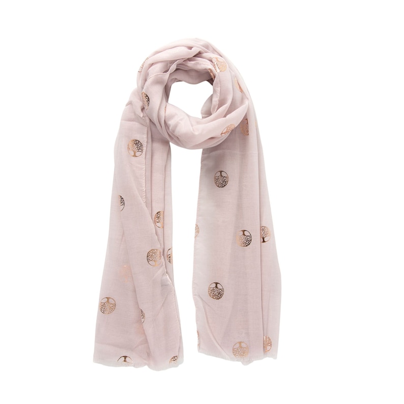 a light pink lightweight scarf around the neck, the scarf has an all over gold foil tree of life pattern, the trees are encased in a circle.