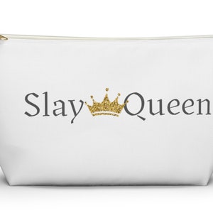 May include: White zippered pouch with a gold glitter crown and the text "Slay Queen" in gray.
