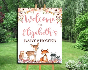 May include: Welcome to Elizabeth's Baby Shower sign with a pink floral design and woodland animals including a deer, owl, fox, and raccoon.