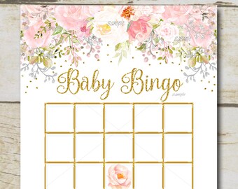 May include: A printable baby bingo card with a floral design in pink, white, and green. The card has a 5x5 grid with blank squares. The text "Baby Bingo" is at the top of the card. The text at the bottom of the card reads "Fill in the blanks with the gifts you think the new mom will receive. Check off the squares as gifts are opened."