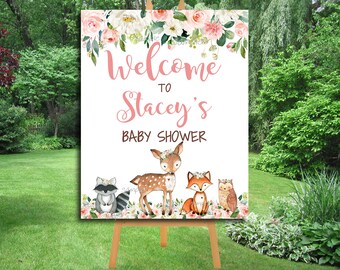May include: Welcome to Stacey's Baby Shower sign with a white background and pink floral border. The sign features a deer, fox, raccoon, and owl with floral accents.