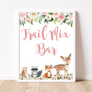 May include: White framed sign with the text "Trail Mix Bar" in pink script, decorated with watercolor illustrations of woodland animals and floral accents. The sign features an owl, raccoon, fox, and deer.