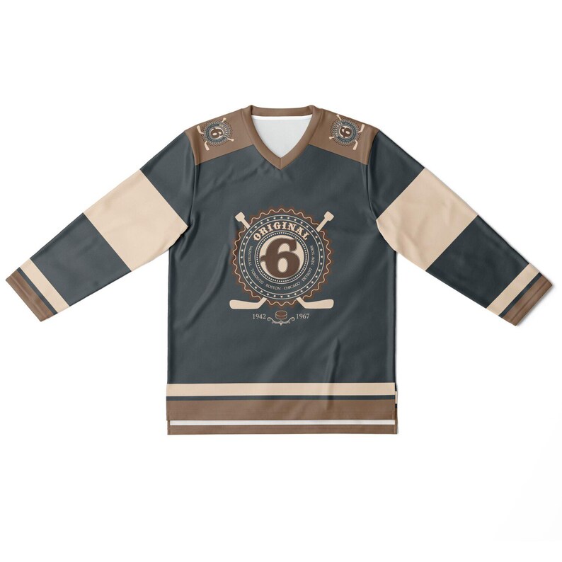 May include: A dark blue hockey jersey with brown and beige accents. The jersey has a large circular logo with the text "ORIGINAL" and the number "6" inside. The logo also includes the text "1942 - 1967".