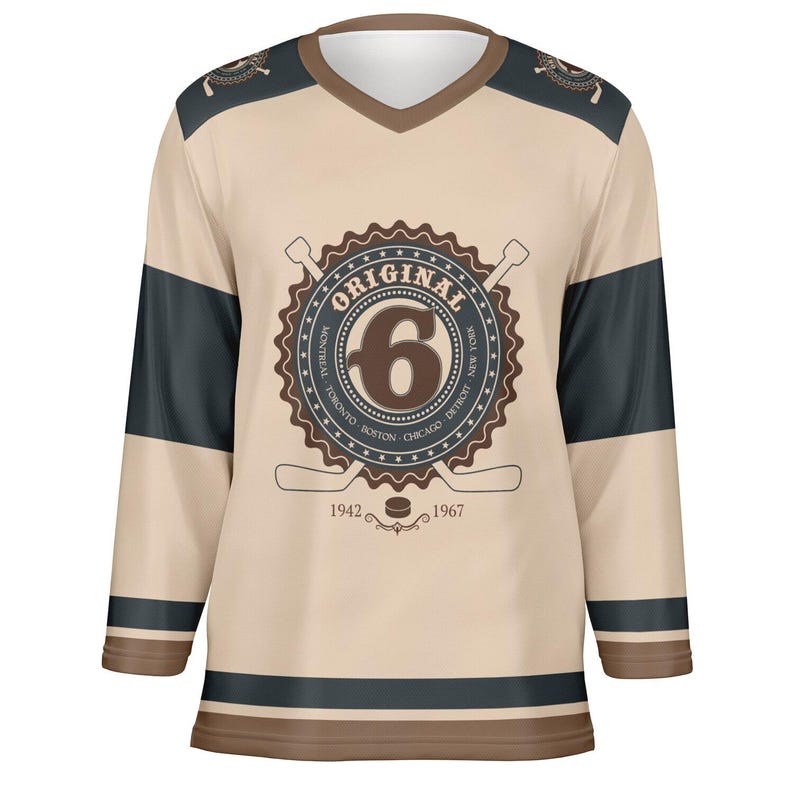 May include: A beige hockey jersey with brown and black stripes. The jersey features a brown circular logo with the text "ORIGINAL" and the number "6" inside. The logo also includes the text "MONTREAL, TORONTO, BOSTON, CHICAGO, DETROIT, NEW YORK" around the number. The text "1942" and "1967" are below the logo.