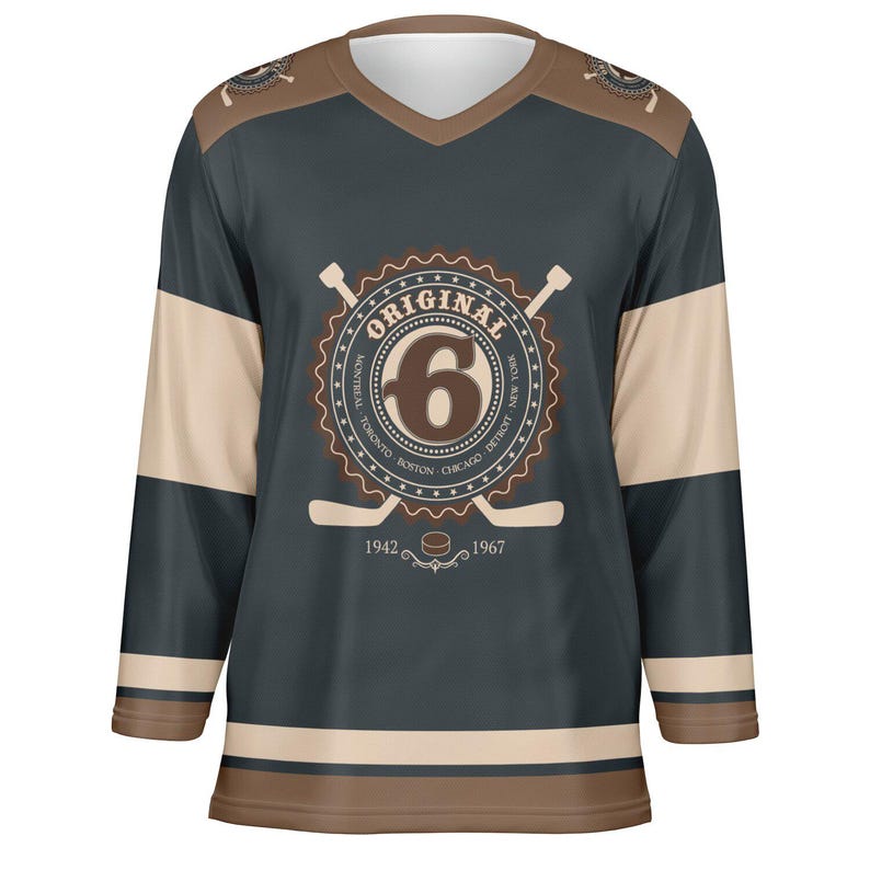 May include: A dark blue hockey jersey with a white and brown striped pattern. The jersey features a large circular logo with the word "ORIGINAL" and the number "6" in the center. The logo is surrounded by the names of six cities: Montreal, Toronto, Boston, Chicago, Detroit, and New York. The jersey also has two crossed hockey sticks and a puck with the years 1942 and 1967.