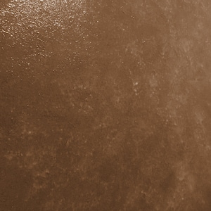 May include: A close-up of a brown textured surface with a subtle sheen. The surface has a slightly rough feel and appears to be made of concrete or a similar material.
