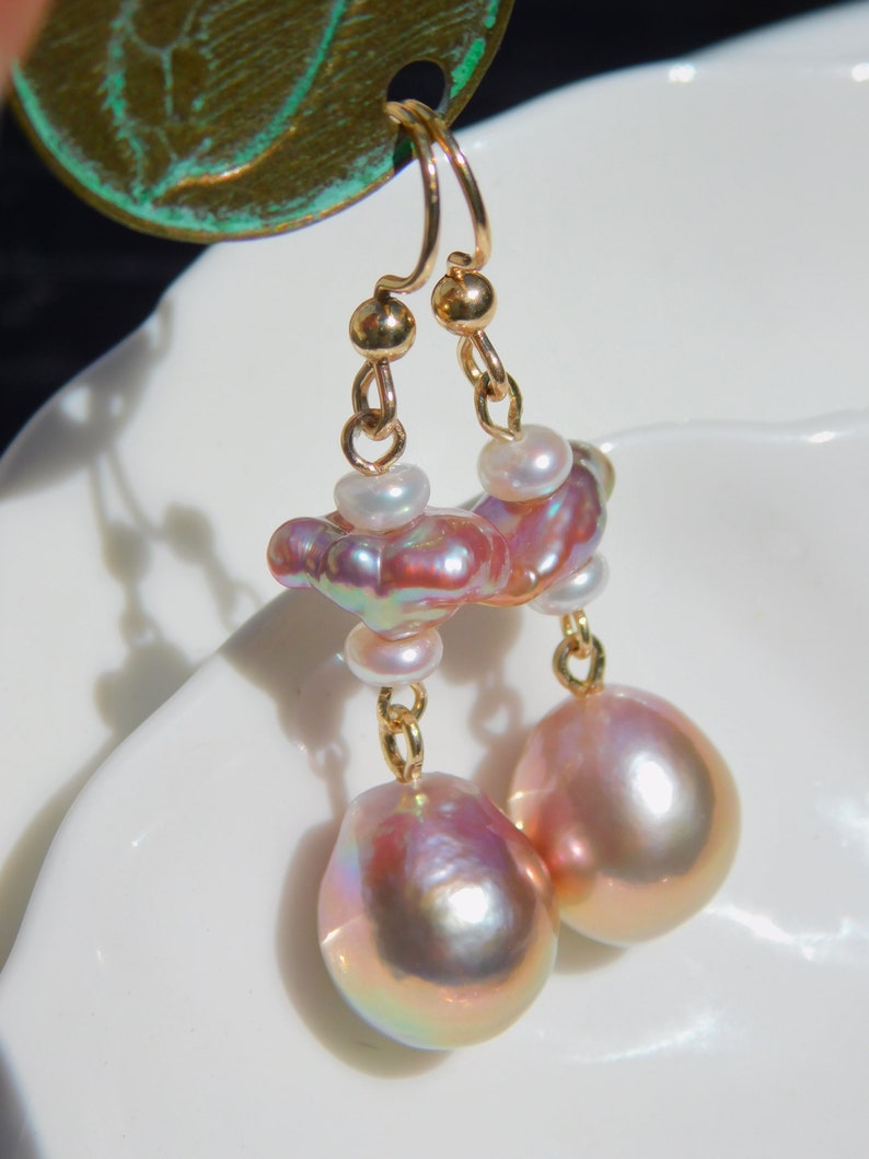May include: Gold earrings with a cluster of pink and white pearls and two large pink pearl drops.