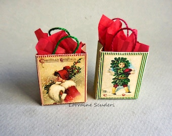 May include: Two miniature gift bags featuring vintage-style Christmas illustrations. The left bag shows a person in a red coat with the text Christmas Greetings. The right bag depicts a figure in a green leafy suit with Best Christmas Wishes.