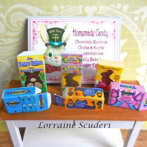 May include: A miniature display of Easter candy boxes including Peeps, Russell Stover, and Bunny Bottom chocolates arranged in front of a sign that reads Homemade Candy, Chocolate Bunnies, Chicks & Ducks, Marshmallows, Jelly Beans, and Sugar Eggs.