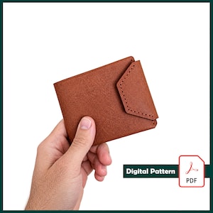 Puede incluir: Una cartera de cuero marrón con una superficie texturizada y un cierre de solapa triangular con costuras visibles a lo largo de los bordes. La cartera se presenta como un patrón digital, indicado por un icono blanco con el texto Digital Pattern PDF.