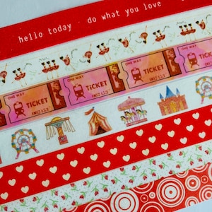 May include: Decorative washi tape rolls with various designs. Includes red glitter tape with the text "hello today" and "do what you love". Other tapes feature ballet dancers, train tickets, and carnival scenes. Additional tapes have heart, floral, and circle patterns.