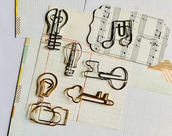 Steampunk, light bulb, vintage camera, skeleton key, music note, paperclip, page marker, book marker