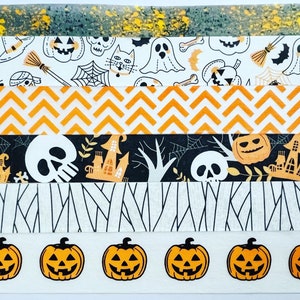 May include: Five rolls of Halloween themed washi tape. The tapes feature different patterns including orange and black chevron, black and white skulls and crossbones, black and white ghosts and bats, and orange and black pumpkins.