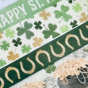 May include: Green and gold washi tape with a shamrock pattern and the text "Happy St. Patrick's Day!" and a green and gold washi tape with a horseshoe pattern.