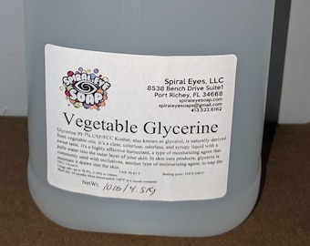 May include: A clear, plastic jug of vegetable glycerine from Spiral Eyes Soap. The jug has a white cap and handle. The label reads "Vegetable Glycerine" and lists ingredients and net weight of 10 lbs / 4.5 kg.