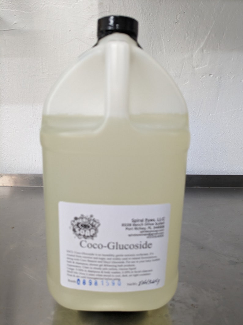 May include: A clear plastic jug with a black lid filled with a light yellow liquid. The label reads "Coco-Glucoside" and includes information about the product and the company, "Spiral Eyes, LLC".