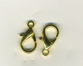 May include: Two gold-tone metal lobster claw clasps. These clasps are commonly used for jewelry making and crafting.