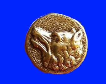 May include: A gold-colored metal button with a detailed wolf head design. The wolf's head is facing to the right and has a textured fur pattern.