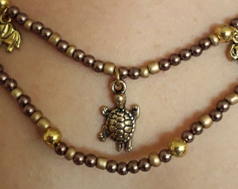 Collier tortue et éléphants dorés, perles en bronze et or, verre et corne, bijou fait-main, création, pièce unique