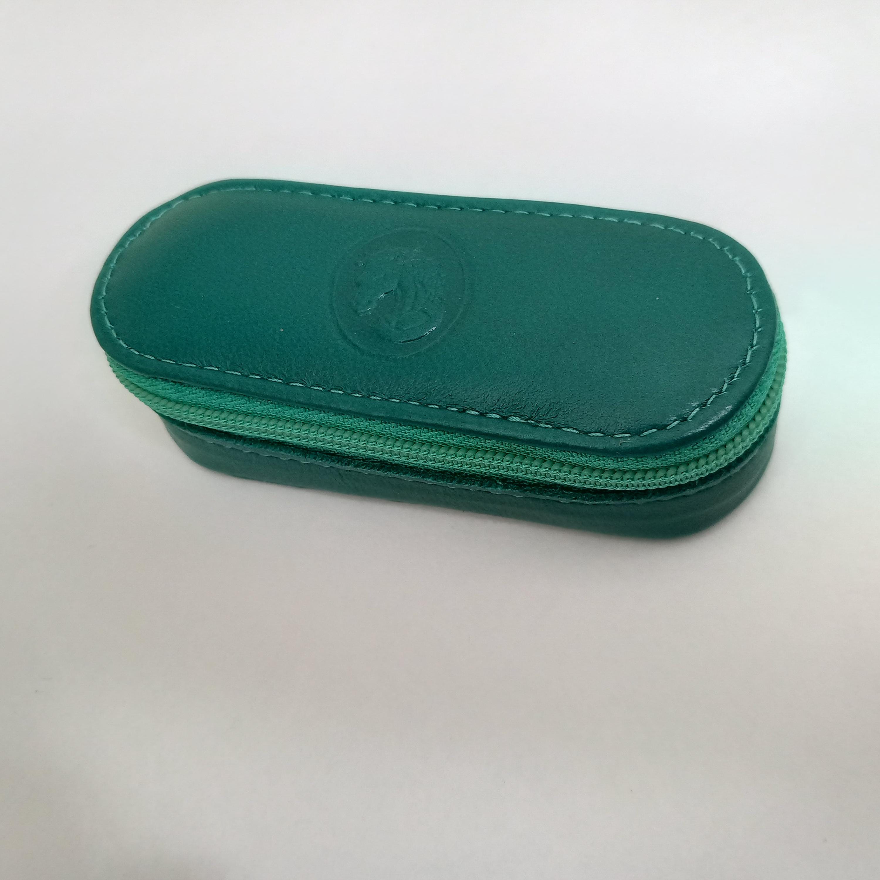 Protective leather lipstick case with interior mirror.