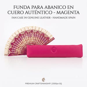 May include: A magenta genuine leather fan case with a textured surface and a small embossed logo, positioned next to an open folding fan featuring magenta fabric, gold floral patterns, and a cream-coloured lace trim along the top edge.