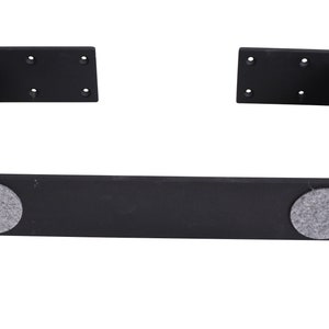 May include: Black metal shelf bracket with two gray felt pads on the bottom.