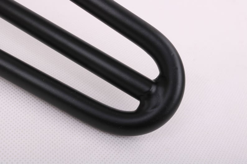 May include: Black metal hairpin leg with a triple-prong design. The leg is curved at the top and has a smooth, matte finish.