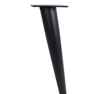 May include: A single black metal furniture leg with a tapered design. The leg has a square mounting plate at the top and a rounded, slightly angled base. The leg is approximately 10 inches tall.