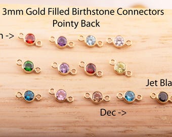 May include: Twelve 3mm gold-filled birthstone connectors with pointy backs. Each connector features a different birthstone color, including red, purple, blue, green, yellow, and black.