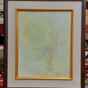 May include: A framed painting of a floral still life with a light green background and a soft, muted color palette. The painting is signed "G.M. Russo" in the lower right corner.