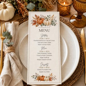 May include: A rectangular Thanksgiving menu card featuring watercolour illustrations of pumpkins, autumn leaves, and wheat. The text lists Starters, Main, and Desserts with specific food items, framed by a thin border on a cream-coloured background.