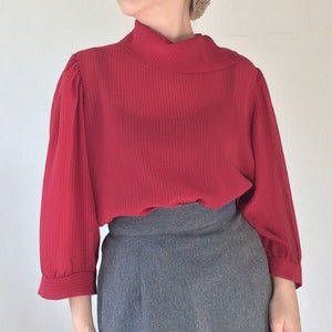 Red top turtleneck blouse