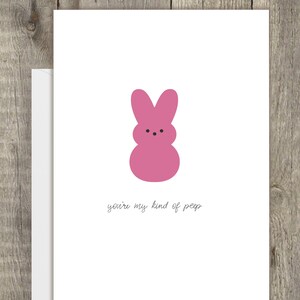 May include: A pink marshmallow bunny with the text "you're my kind of peep" on a white card.