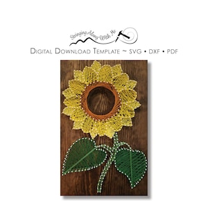 May include: A string art sunflower with yellow petals, an orange center, and green leaves on a brown wooden background. The image includes the text "Stringing Along With Me".