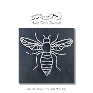 May include: A white string art bee design on a dark wood background. The bee is outlined with white string and has a detailed body and wings.