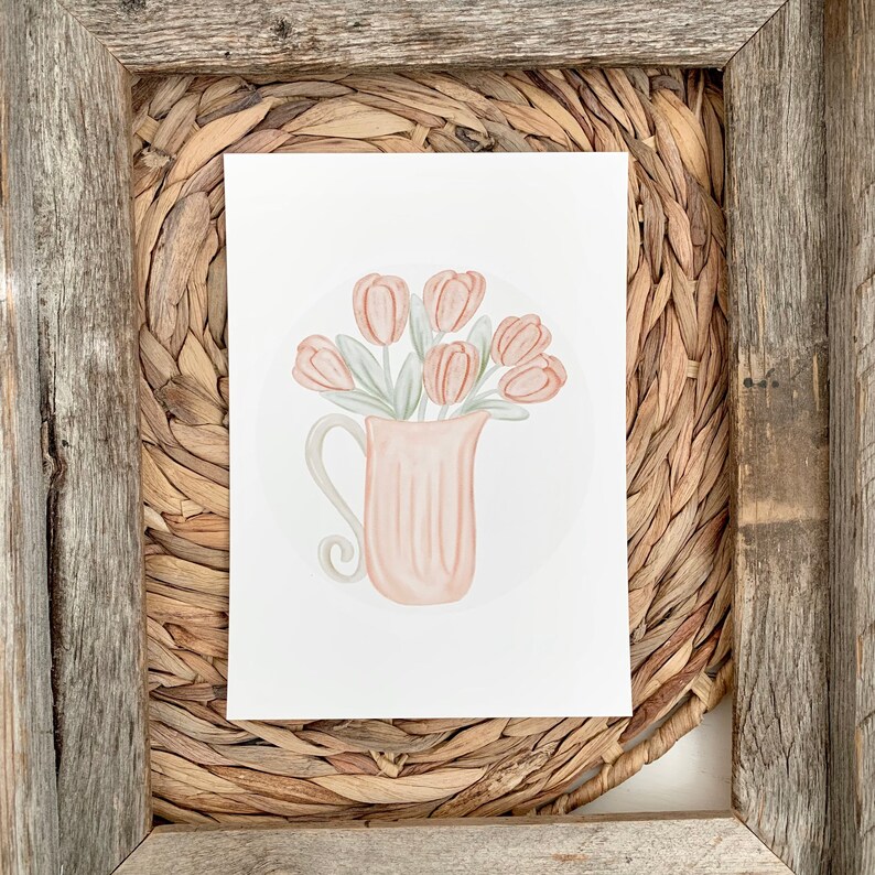 May include: A watercolor illustration of a pink pitcher filled with a bouquet of peach-colored tulips. The pitcher has a delicate handle and is sitting on a white background.