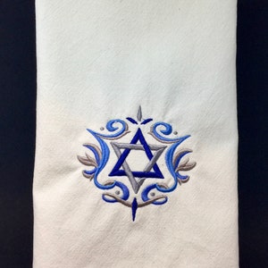 May include: White kitchen towel with a blue and gray embroidered Star of David design.