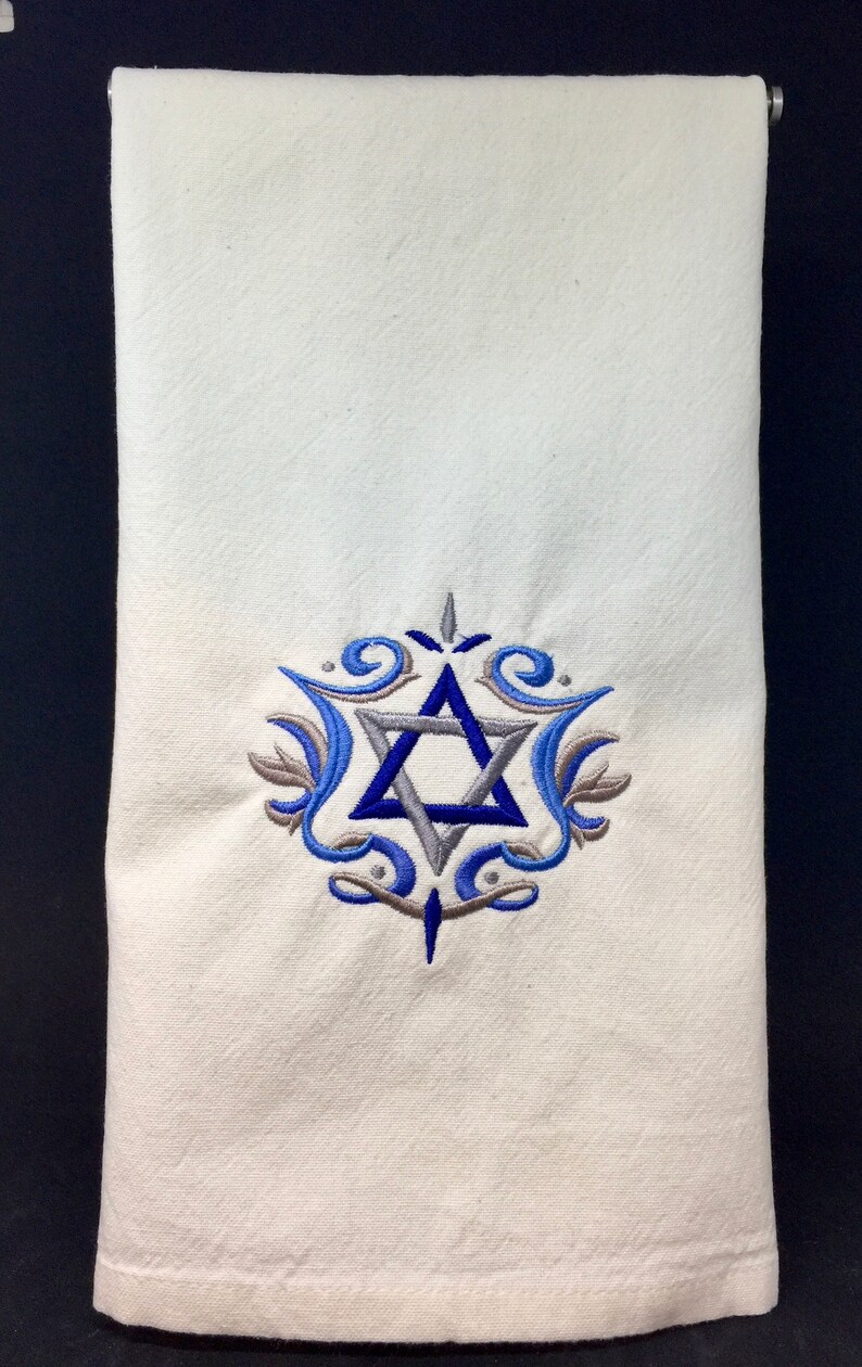 May include: White kitchen towel with a blue and gray embroidered Star of David design.