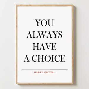 May include: A black and white motivational quote print in a wooden frame. The quote reads "You always have a choice - Harvey Specter -"