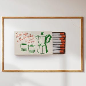 May include: A matchbox with a green and white illustration of a coffee pot and two cups. The text on the matchbox reads "Good coffee is like friendship - rich and warm and strong".