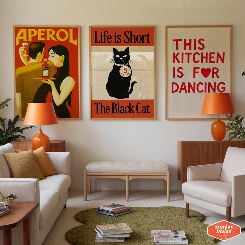 May include: Three framed posters with different designs. The first poster is a vintage advertisement for Aperol featuring a man and woman. The second poster features a black cat with the text "Life is Short, The Black Cat". The third poster has the text "This Kitchen is for Dancing" with a red heart.